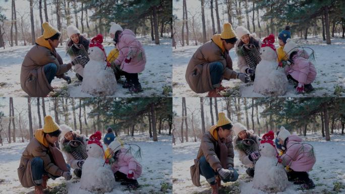 快乐家庭在雪地里堆雪人