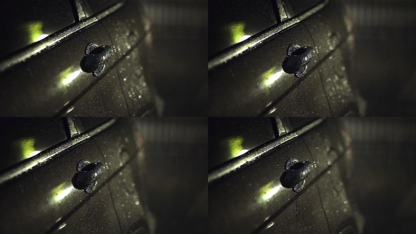 夜间停车场汽车上的雨滴
