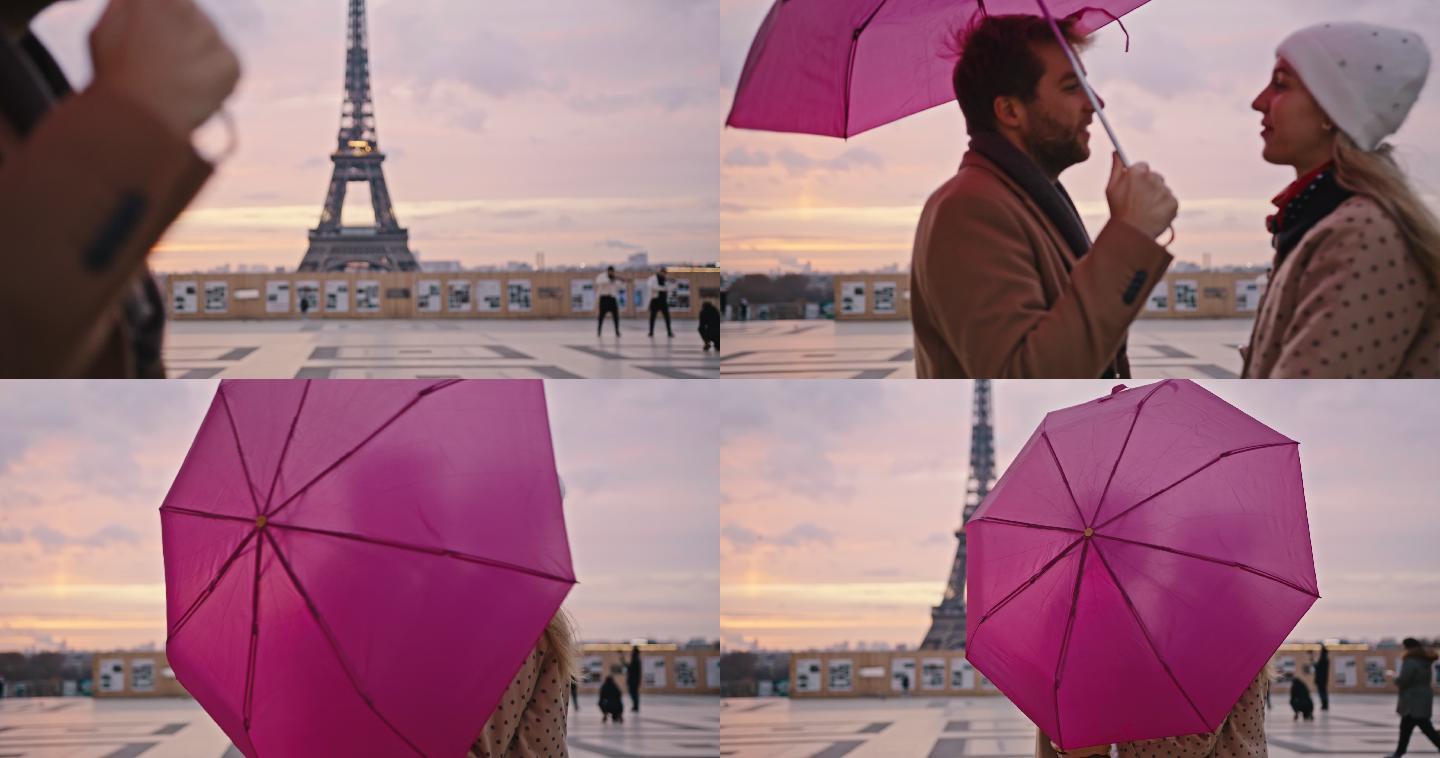 巴黎埃菲尔铁塔旁，斯洛莫恋人在雨伞后亲吻