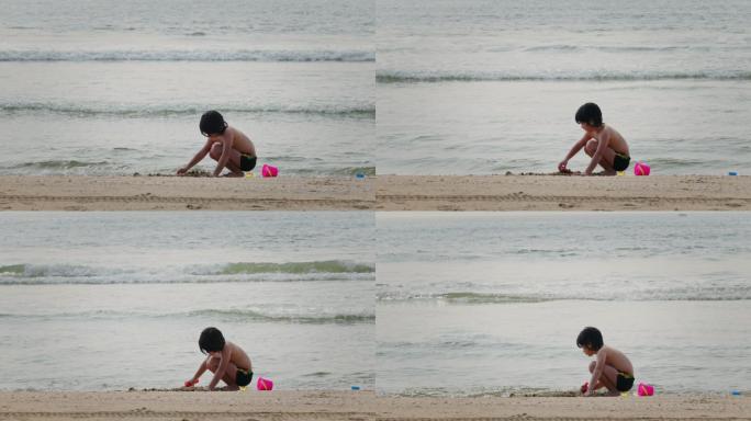 6-7岁混血男孩在沙滩上玩沙子