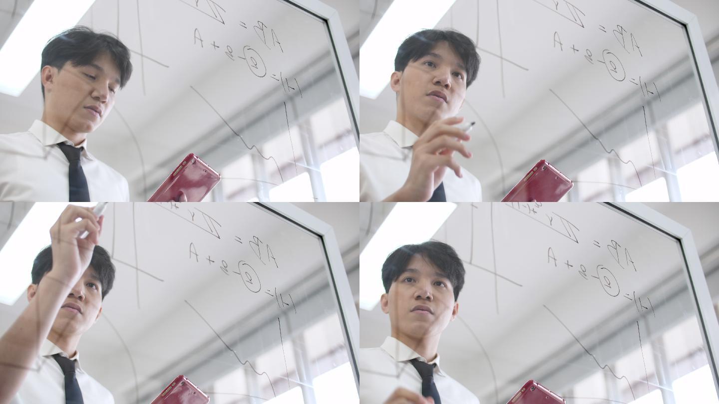 商人在玻璃白板上写数学方程式，寻找解决方案和工作理念
