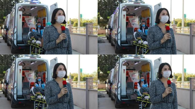 一名戴口罩的女新闻播音员在大流行期间在医院前报道突发新闻