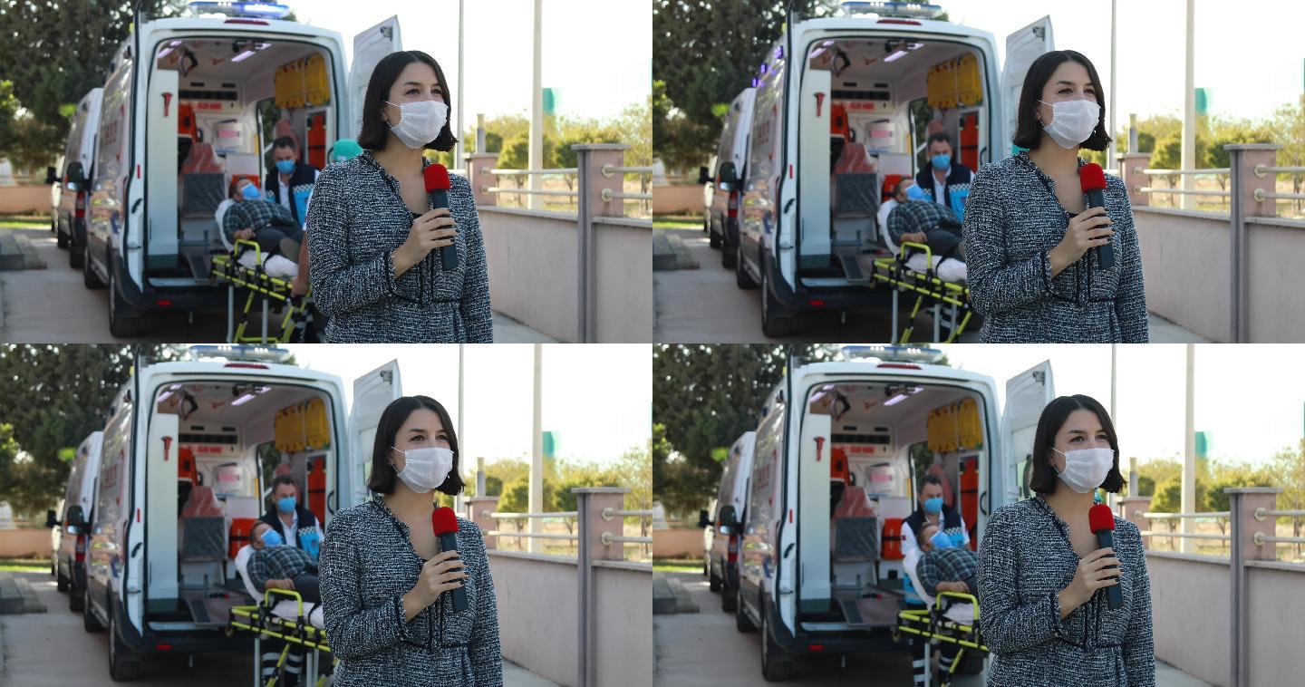 一名戴口罩的女新闻播音员在大流行期间在医院前报道突发新闻
