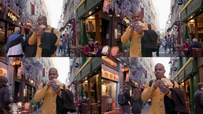 男性游客在巴黎漫步，吃着煎饼