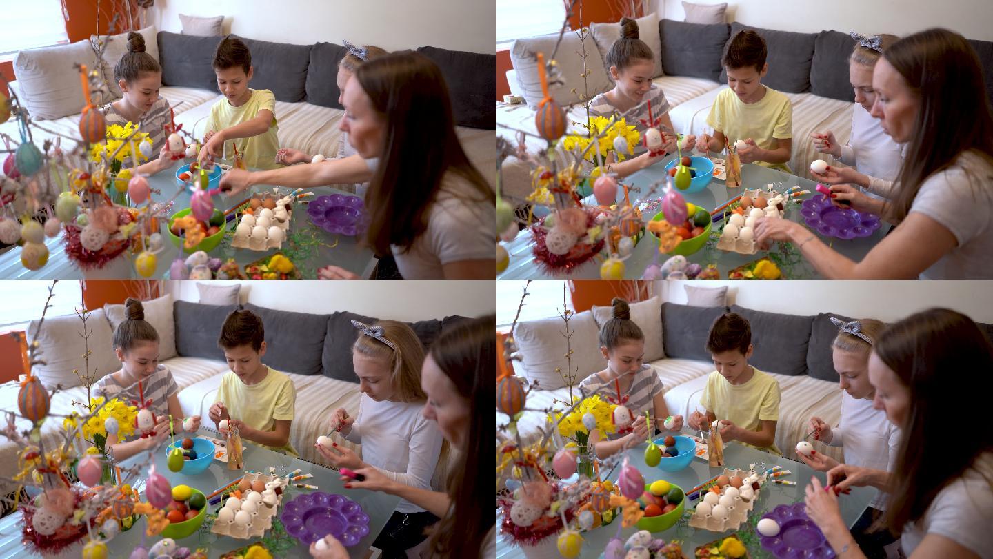 母亲和孩子们在家里画复活节彩蛋