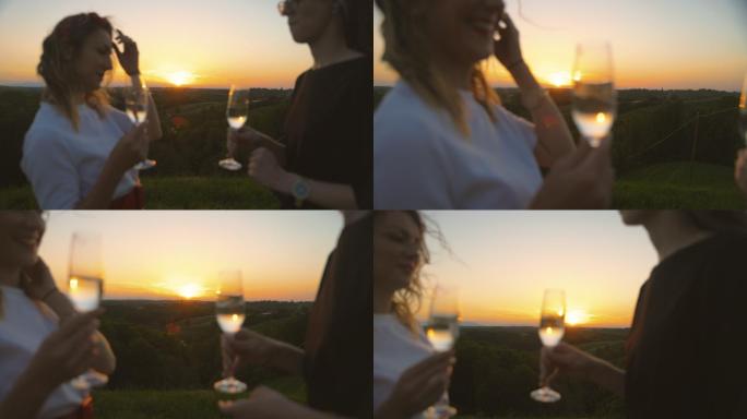 日落时分，两位年轻女子举杯祝酒