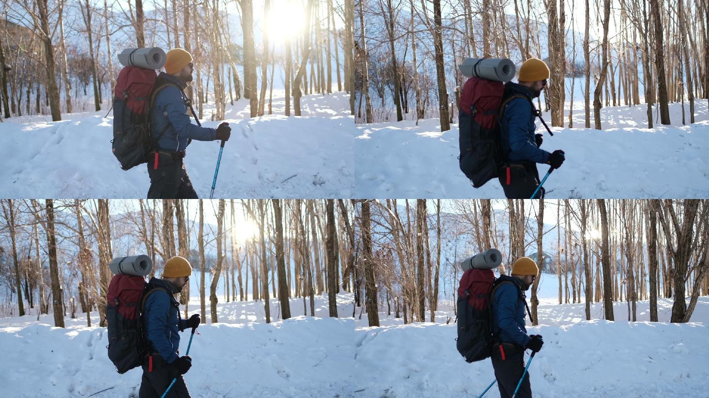 冬天背着背包在山上徒步旅行的男人