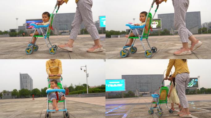 妈妈带小孩推婴儿车广场散步