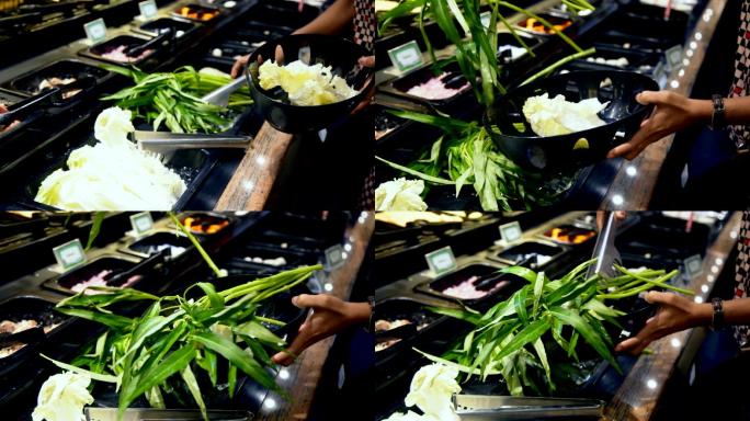 女子将生蔬菜牵牛花挑进塑料筐中，准备Sukiyaki涮饭