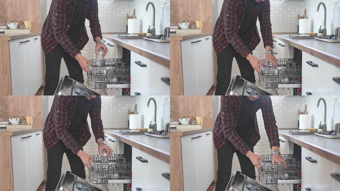 男性将脏盘子放入洗碗机的特写镜头
