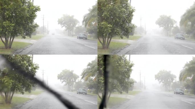 汽车停在路边，卡在雨中挡风玻璃刮水器打开