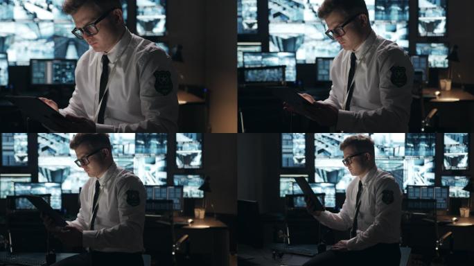 摄像头将拍摄安检人员在平板电脑上工作的特写镜头，然后摄像头移动到安检室的总平面图。