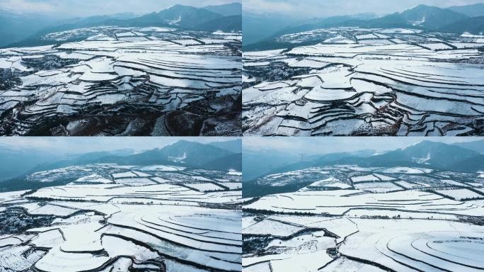 冬季白雪覆盖山川线条明显田野远处连绵雪山