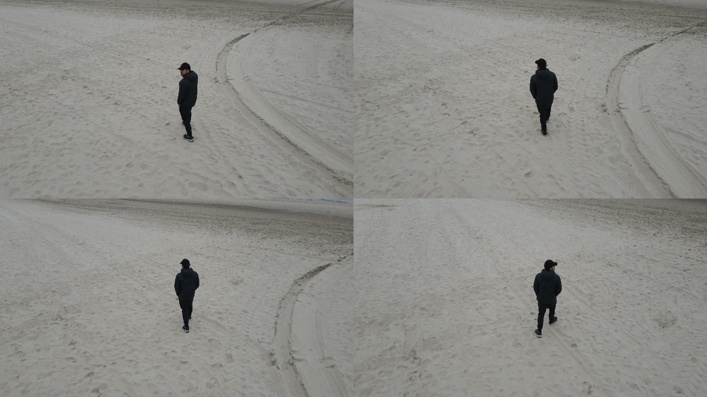 一个人孤独地走在德国北海的海滩上