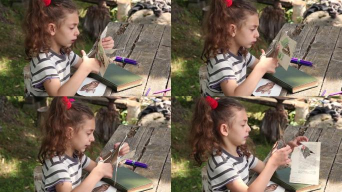 一个小女孩在后院剪纸贴花的侧视图