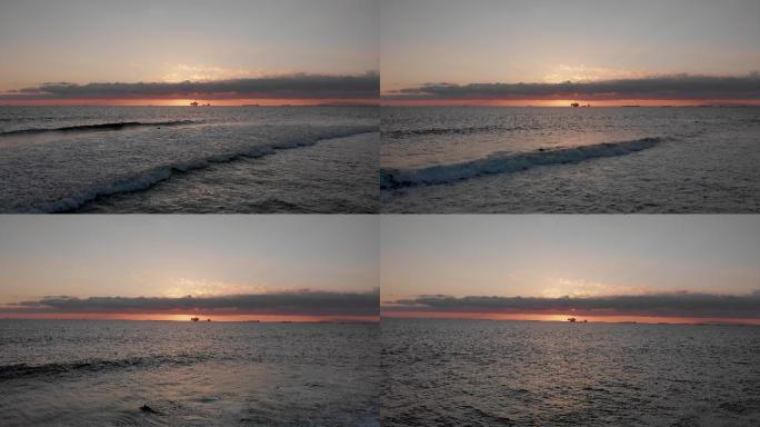 洛杉矶亨廷顿海滩附近南加州海岸外太平洋海上油气压裂钻井平台的无人驾驶日落画面