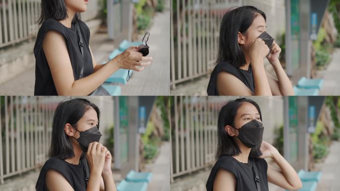 巴士站戴口罩的亚洲女性