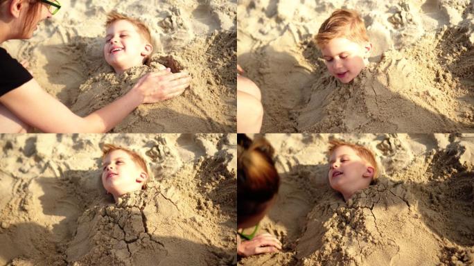 男孩被埋葬时微笑亲情沙滩玩乐