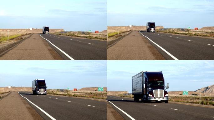 黎明或黄昏时分，在沙漠中沿四车道公路行驶的长途半卡车和拖车