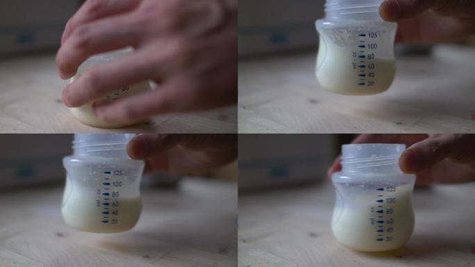 母亲准备婴儿配方奶粉的特写镜头