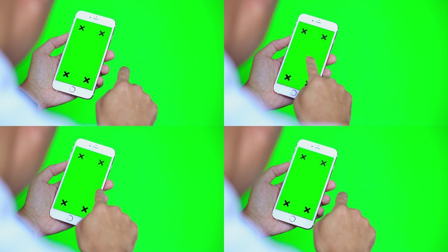 绿色屏幕和绿色背景的智能手机肩拍