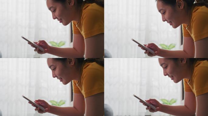 亚洲女性在家使用手机