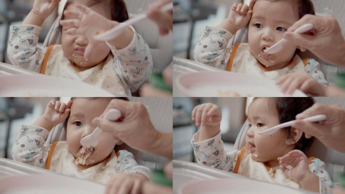 正在吃妈妈喂的食物的女婴。