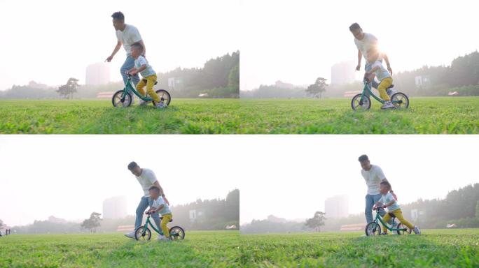 傍晚父亲教孩子在草地上骑单车