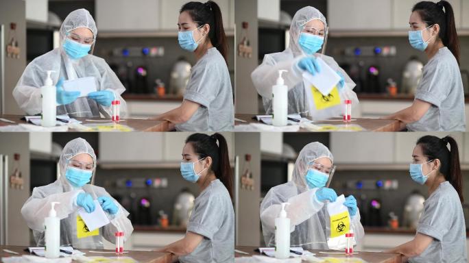 中国亚裔女医生带着PPE在患者用鼻拭子擦拭后将试管插入生物危害标志包装中