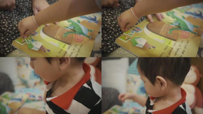 2-3年，亚洲小男孩和妈妈一起在家玩字母贴纸。