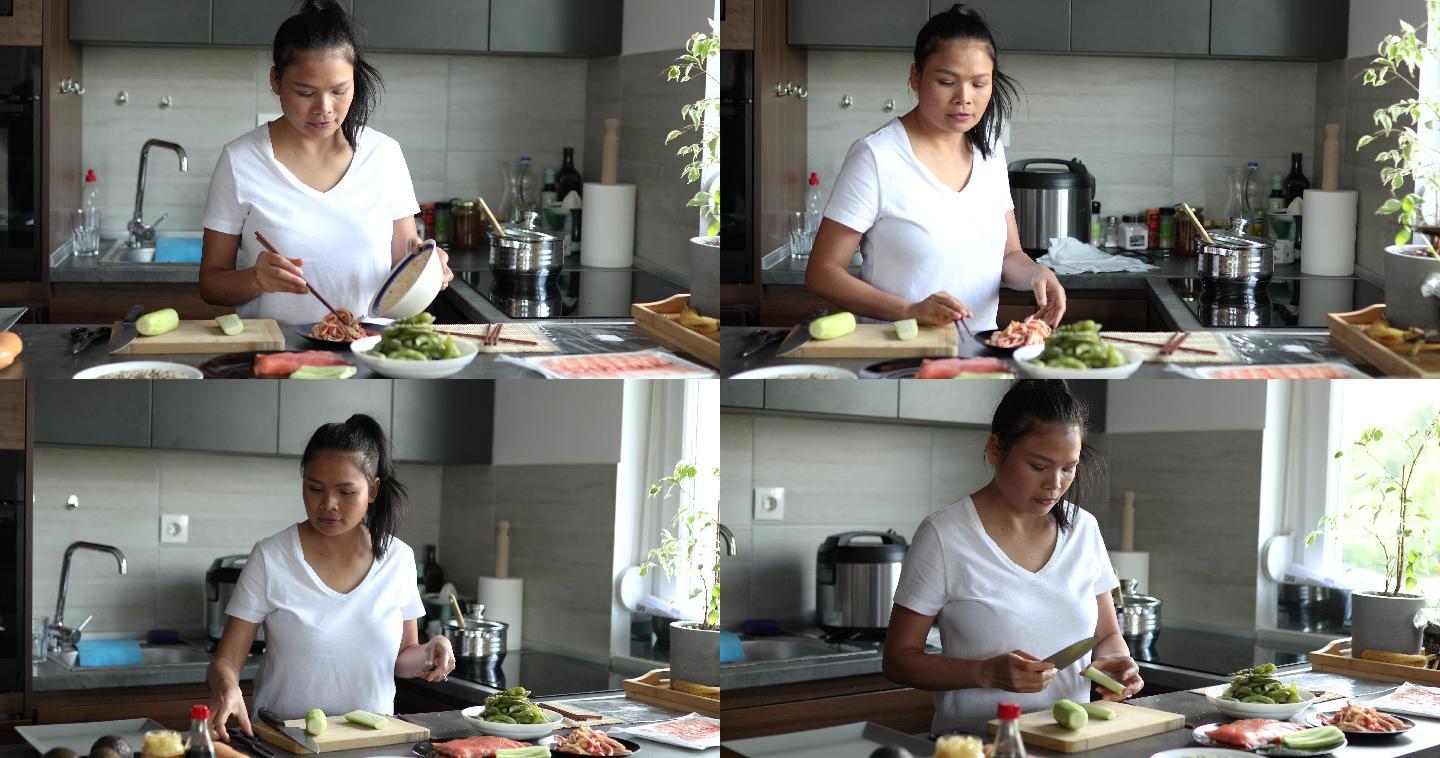 一位泰国妇女在她的现代家庭厨房里准备寿司的所有配料