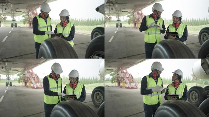 亚洲男女工程师维护飞机团队在机场对飞机前部进行维修、修理、现代化和翻新。