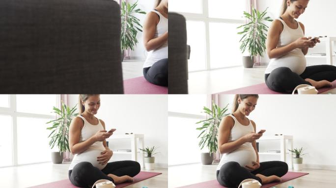 美丽的孕妇一边练习瑜伽一边打电话。
