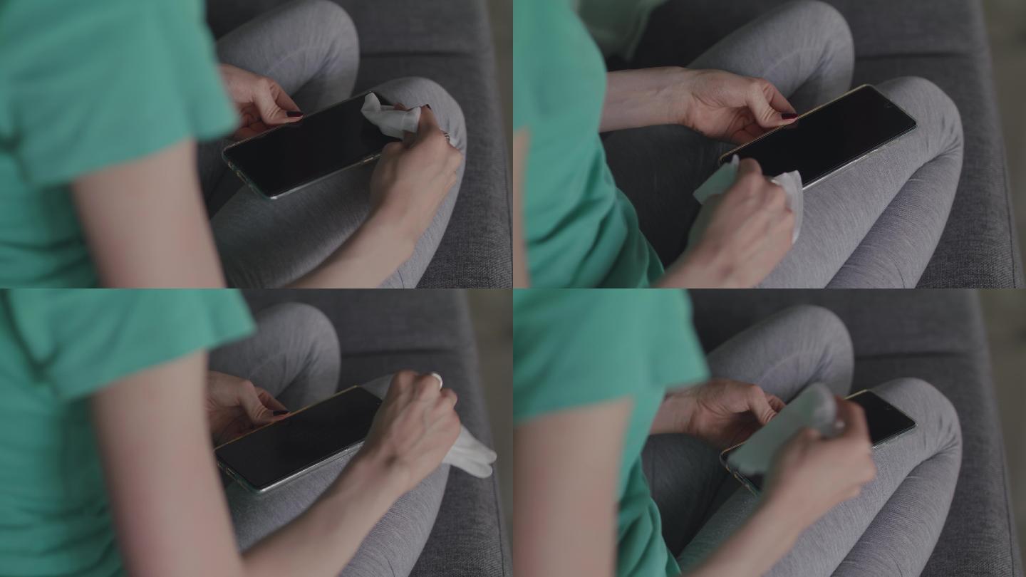 女性使用抗菌湿巾消毒智能手机