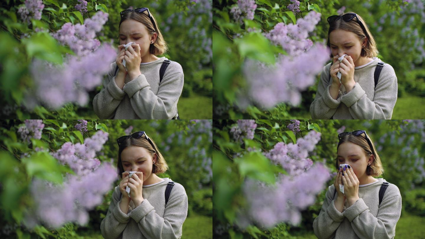 春天鲜花盛开的公园里，一个打喷嚏、擤鼻涕过敏的女孩