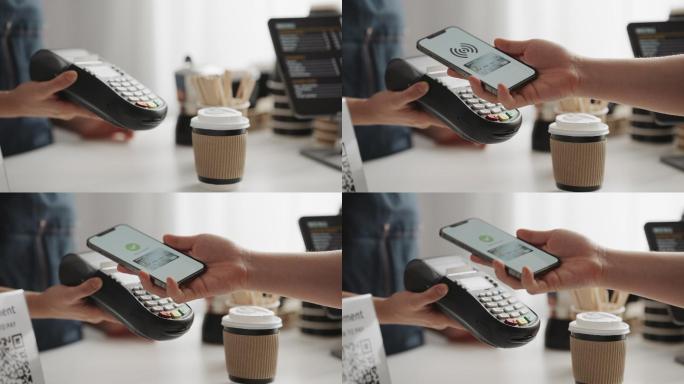 手持式移动电子钱包应用的特写镜头在信用卡读卡器上进行非接触式支付