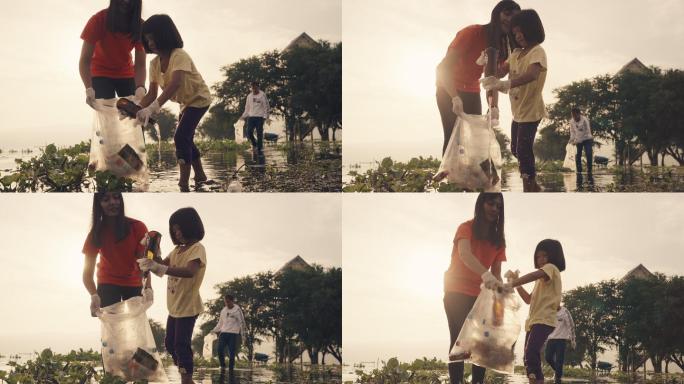 晚上，亚洲志愿者家庭在河边收集塑料瓶和水葫芦。