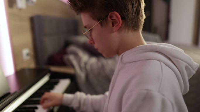 少年在家练习钢琴弹钢琴琴键演奏
