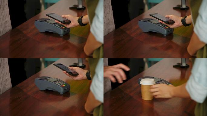 特写镜头：客户通过智能手机进行非接触式付款，在咖啡厅咖啡厅的柜台酒吧购买外卖咖啡，慢镜头