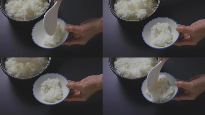 把米饭盛在碗里。盛饭用餐吃饭
