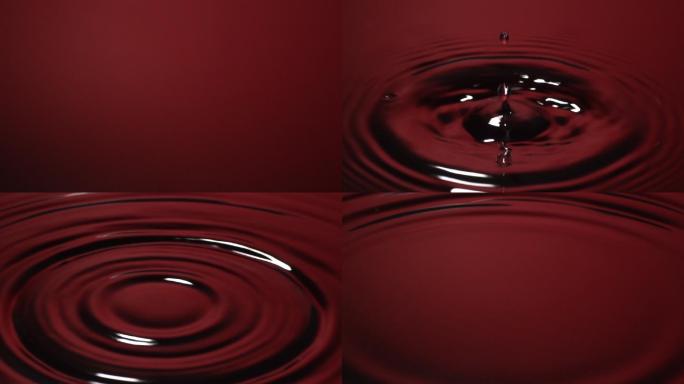 慢动作：水滴落入红色水中。