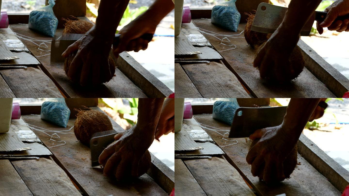 亚洲老人用刀切椰子