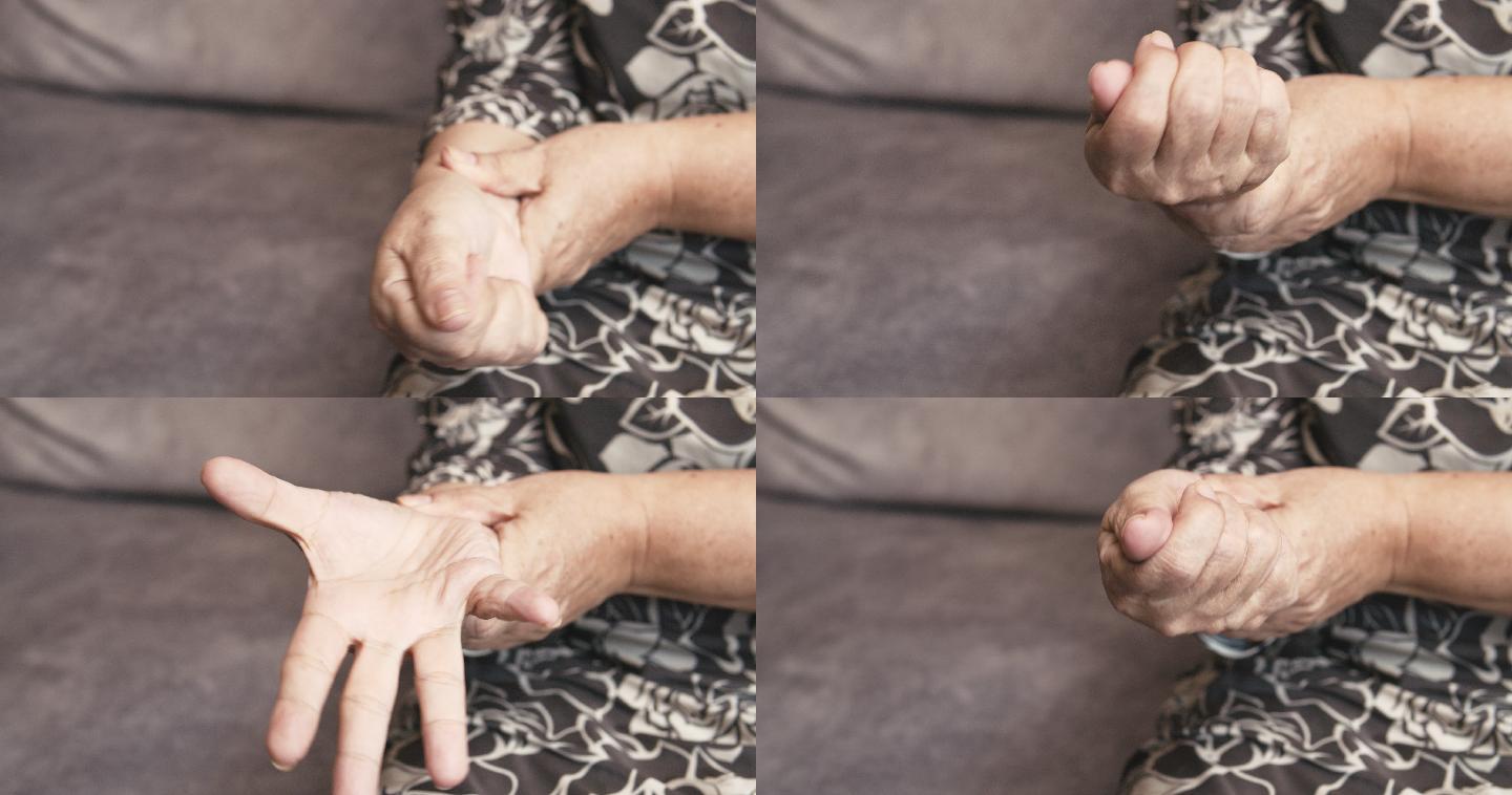 坐在沙发上的亚洲老年女性手部疼痛。按摩她的手