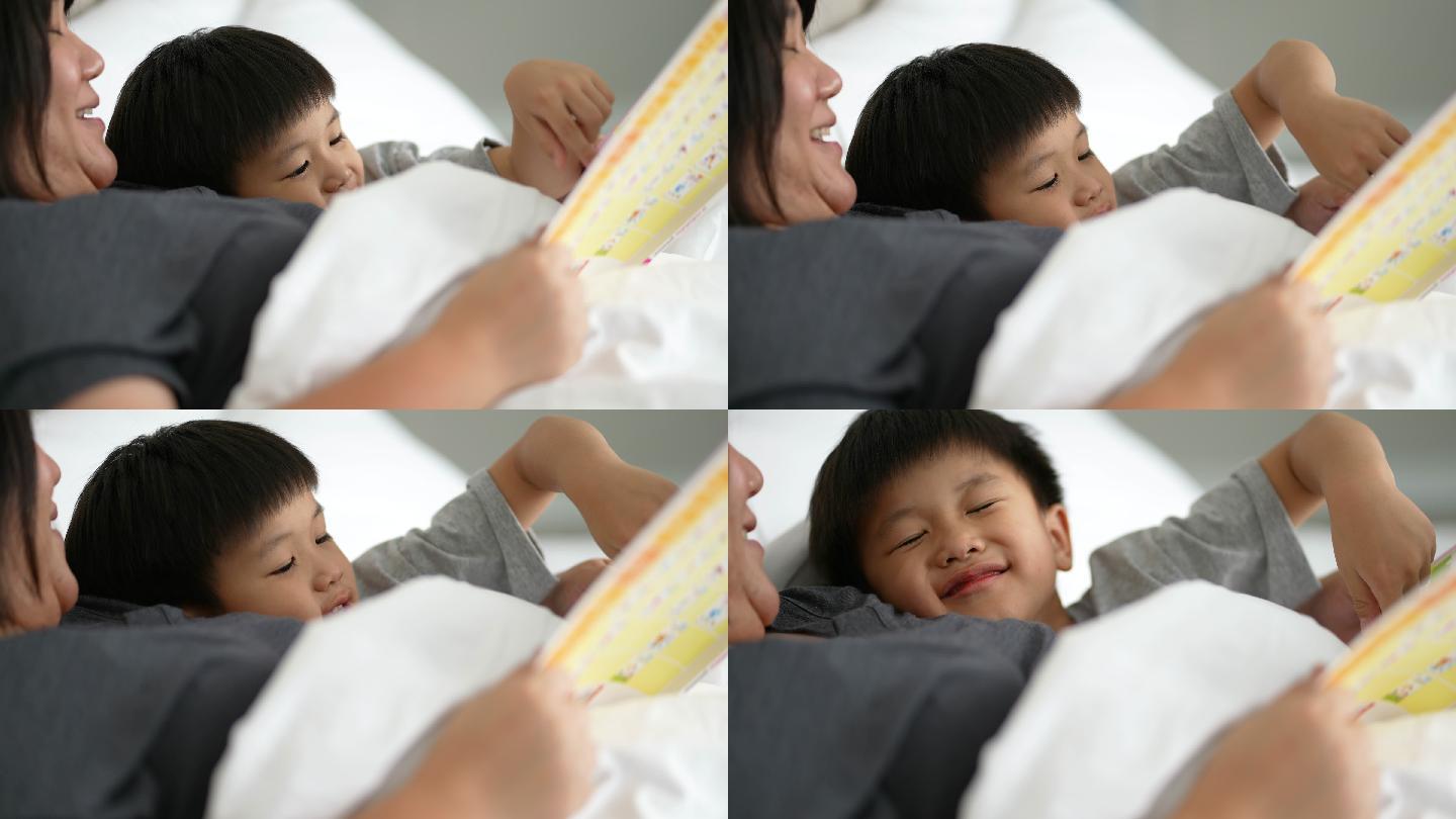 亚洲孩子和妈妈在卧室里读《睡前故事》。家庭时间的概念