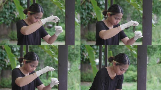 年轻的亚洲女性用家用新冠病毒检测试剂盒擦拭鼻子。