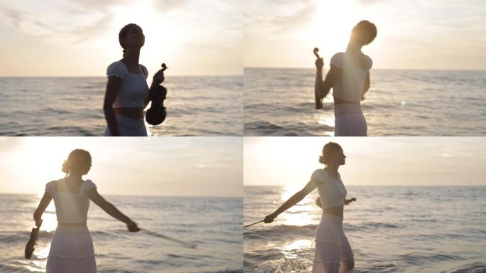日落时分，十几岁的女孩拉着小提琴在海滩上散步