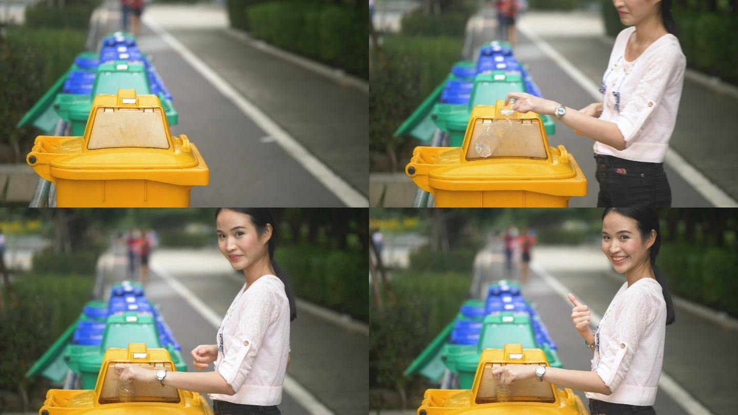 亚洲女性将塑料瓶扔进垃圾桶