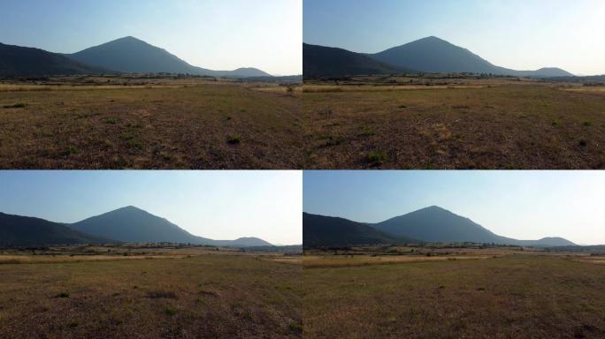 日落时分，飞越一片草地，飞向一座金字塔形的山，塞尔维亚东部的塔尼杰山