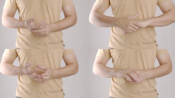 亚洲成年男子手部疼痛的4k镜头。按摩他的手