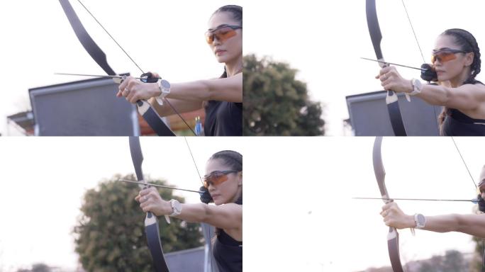 近距离拍摄在射箭场练习射箭的迷人亚洲女性。